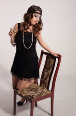 Young sexy girl posing in flapper style dress