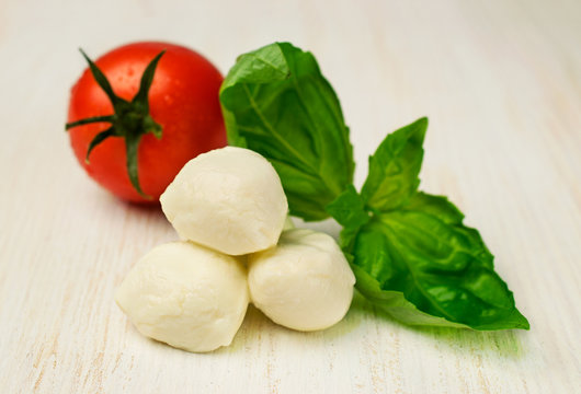 Ingredients for Caprese : mozzarella , cherry tomatoes and basil