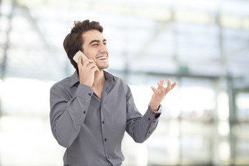 Young businessman talking mobile phone in the office