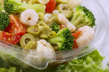 Fresh prepared salad in a bowl to take