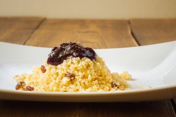 Morsels with jam on white plate, closeup