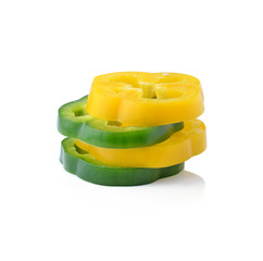 Sliced green and yellow pepper isolated on white