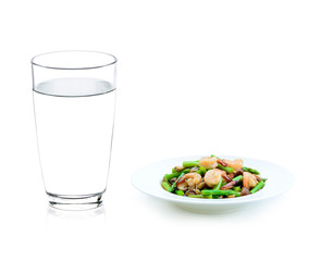 Glass of water and asparagus stir fried with prawns