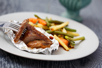 Cooked duck fillet served with vegetables