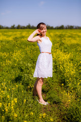 Fototapeta premium beautiful girl in a flowering field