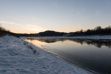 Fototapeta na wymiar beautiful snowy winter landscape with frozen river