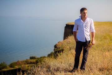 groom on the precipice in the mountains