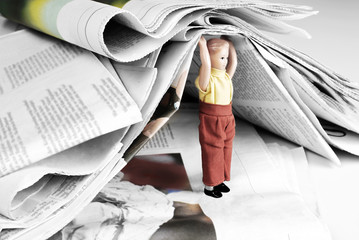 Information Burden - Mini Human Figure of Man or Child Holding Heap of Newspapers 