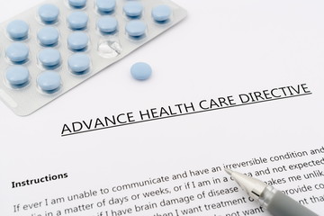 advance health care directive with blue pills ans grey pen