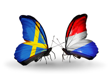 Two butterflies with flags Sweden and Luxembourg