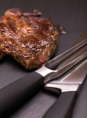 fresh, grilled beef steak on wooden background 