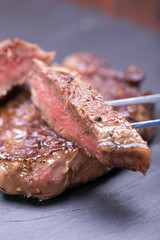 fresh, grilled beef steak on wooden background 