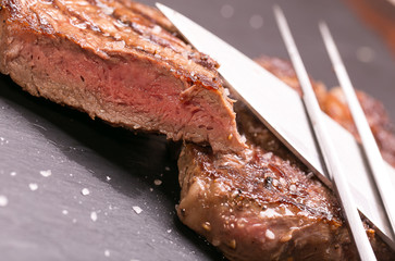 fresh, grilled beef steak on wooden background 