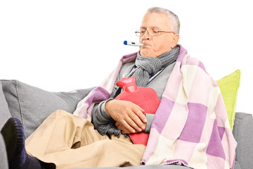 Fototapeta premium Sick senior measuring his body temperature