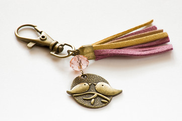 Keychain made with gold color metal and thong