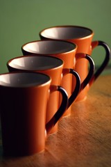 row of ceramic coffee mugs