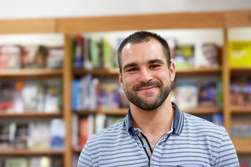 Portrait of cheerful man in a bookstore