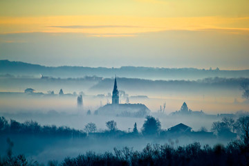 Krizevci cathedral in fog landscape