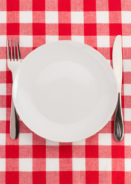 knife and fork at plate on napkin