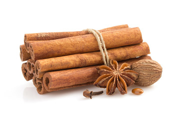 cinnamon sticks, anise star and spices on white