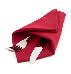 knife and fork at napkin on white