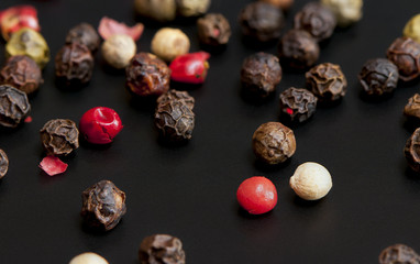 Red, black, green and white peppercorns