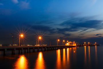 Fototapeta na wymiar Small port ship and reflect lamp in night time