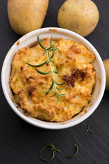 dish of potato souffle with rosemary
