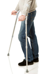 Close up on male legs with crutches