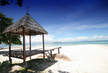 Hut on White Beach and Blue Sky