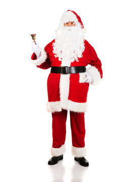 Full length Santa Claus holding a bell