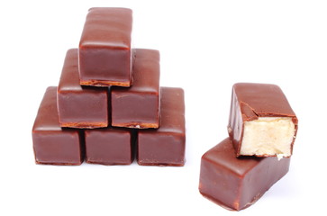 Stack of chocolate sweets on white background