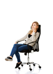 Fototapeta premium Young woman sitting on armchair touching chin