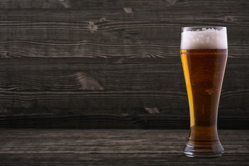 Glass of beer on a wooden countertop