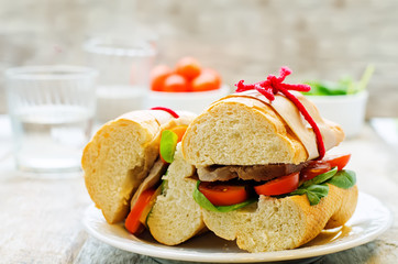 sandwich with meat, spinach and tomato