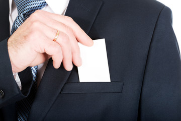 Businessman taking a blank card from pocket