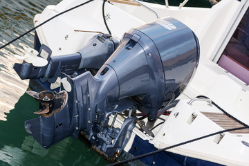 Pair of outboard motors mounted on a white fiberglass hull