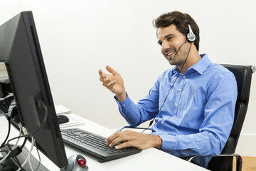 Attractive unshaven young man wearing a headset 