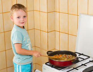 Child prepares meat on the plate