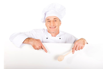 Chef in white uniform holding empty banner