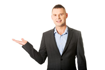 Smiling businessman holding copyspace