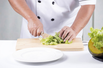 Chef cutting lettuce