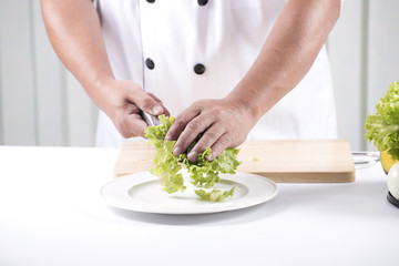 Chef cutting lettuce