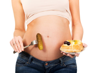 Pregnant woman with cake and pickle