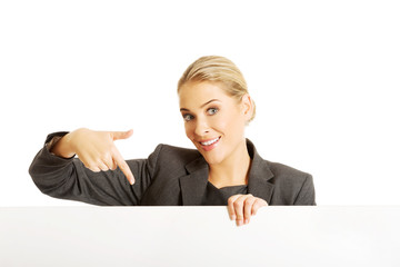 Businesswoman holding empty billboard