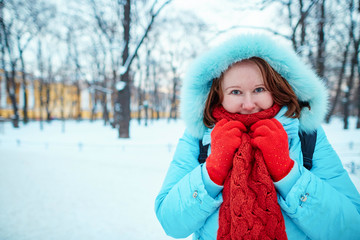 Girl in red scarf in park on a cold winter day