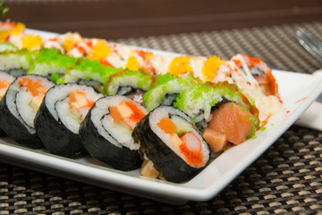 Japanese seafood sushi roll on the white plate.