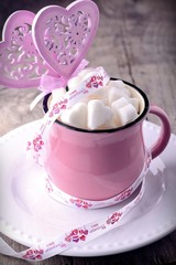 Pink cup with sugar cubes in shape of heart from above