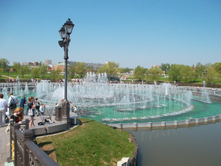 Fototapeta premium Fountains in the city. Lamp post. People