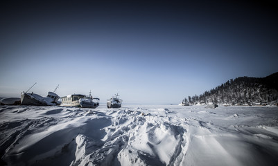 Fototapeta na wymiar Old ships on the ice of Lake Baykal. Toned